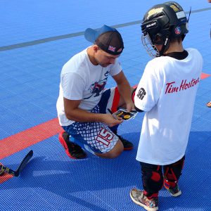 image of: stick skillz academy kid and instructor